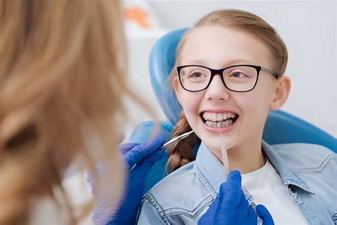 A Beautiful girl sitting in a dentist office